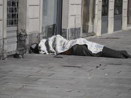 a homeless sleeping on public place with a dog photo