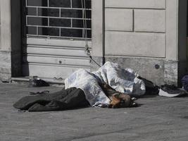 a homeless sleeping on public place with a dog photo