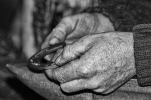 old retired man hands working photo