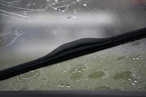 heavy rain on car windscreen wiper photo