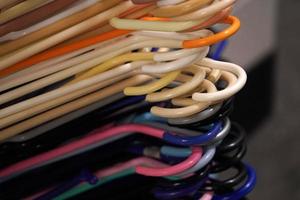 many coat hangers in storage room hook close up photo