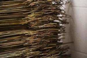 many coat hangers in storage room hook close up photo