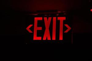 exit red light sign on black photo