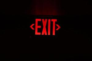 exit red light sign on black photo