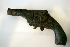 old rusted pistol being underwater for long time photo