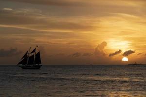 beautiful sunset with sailboat in key west photo