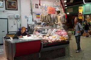 FLORENCE, ITALY - SEPTEMBER 1 2018 - People buying at old city market photo