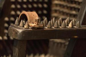 Torture iron spikes medieval chair photo