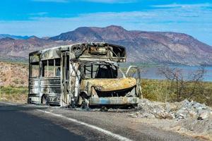 burned school bus on california road photo