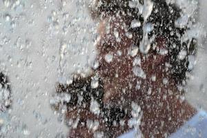 people inside rockfeller center fountain splash in new york manhattan photo