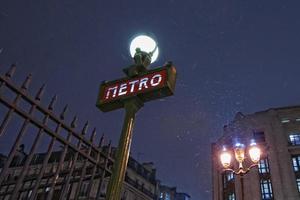 Paris Metro Metropolitain Sign while snowing photo