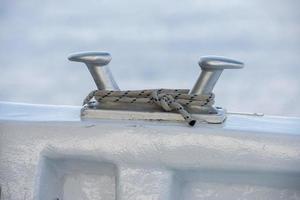 boat bollard detail on blue water background photo