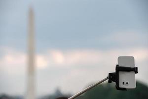 selfie remote on cellular phone at Washington Monument Obelisk photo