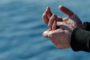 Sailor hands on blue sea background photo