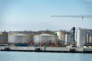 metallic silos on cloudy sky photo