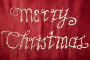 merry christmas embroidery on red fabric photo