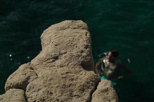 diving from saint peter pools Malta rock formation hole on rocks photo