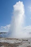 Geyser blow in Iceland while blowing water photo