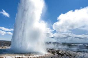 Geyser eruption in Iceland while blowing photo