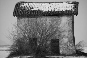 Old brick house covered by snow photo