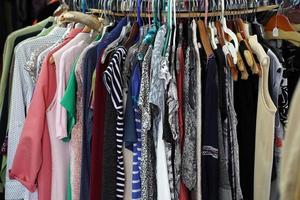 Vintage used clothes for sale inside a shop photo