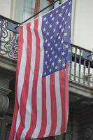 Usa American flag waving from italian balcony photo