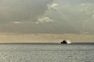 A boat on turquoise tropical paradise sea photo