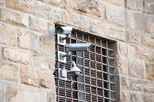 security cameras on ancient wall photo