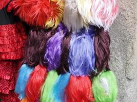 Colorful wig accessories. Sales at the market. Different wigs for women. photo