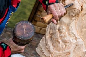 sculptor detail while carving wood photo