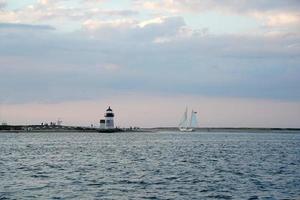 lighthouse of nantucket harbor view at sunset photo