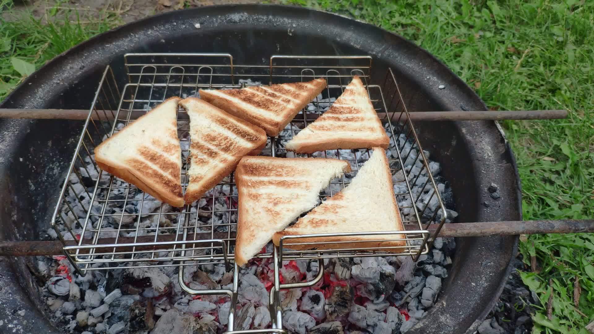Toast bread for sandwiches being made on a campfire in garden. Homemade