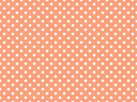 white polka dots over light salmon background vector