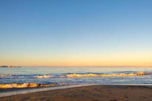 Beautiful sunny sunrise on the beach photo
