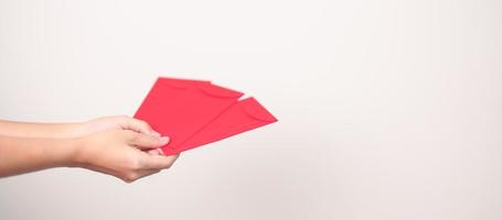 Woman holding Chinese red envelope, money gift for happy Lunar New Year holiday photo