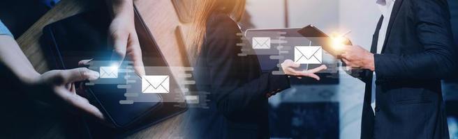 Businessman hands using Laptop typing on keyboard and surfing the internet on office table with email icon, email marketing concept, send e-mail or news letter, online working internet network. photo