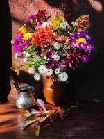 Home decor and flowers arranging. A bouquet with autumn flowers photo