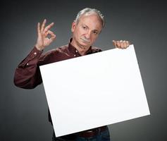 old man holding empty bill board photo