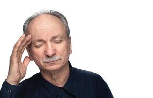 Elderly man suffers from headache photo