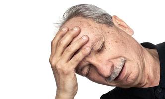 anciano sufre de dolor de cabeza foto