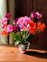 Spring romantic bouquet with garden colorful tulips in the interior photo