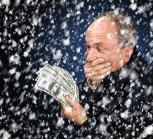 man with a bundle of dollars in snowfall photo