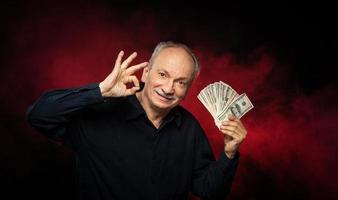 old man with dollar bills photo