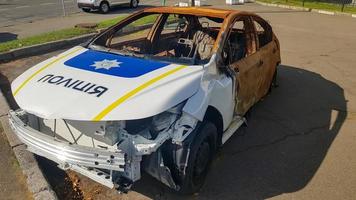 Burnt out police car. Vandalism, burned car. Car after the fire. Auto trash. Destroyed patrol car of the Ukrainian national police. Translation - Police, Ukraine, Kyiv - October 9, 2022. photo