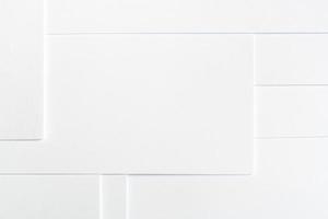 Abstract white minimalist background of clean paper sheets neatly laid out in geometric pattern. photo
