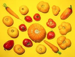 Pattern of fresh farm vegetables on bright yellow background. Top view, flat lay. photo