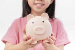 girl hands hold a pink piggy bank . The concept of saving money or savings, investment photo