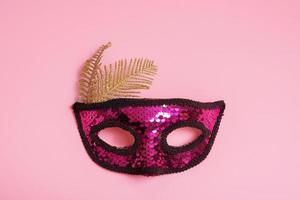 Festive face mask for carnival celebration on colored background photo