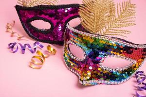 Festive face mask for carnival celebration on colored background photo