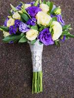 bridal bouquet of purple and wedding rings photo